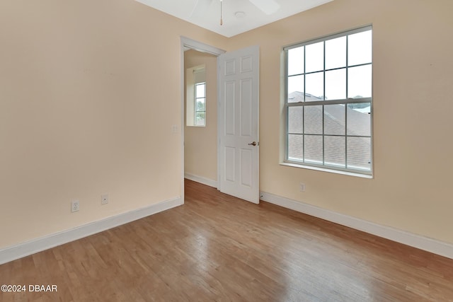 spare room featuring ceiling fan and light hardwood / wood-style flooring