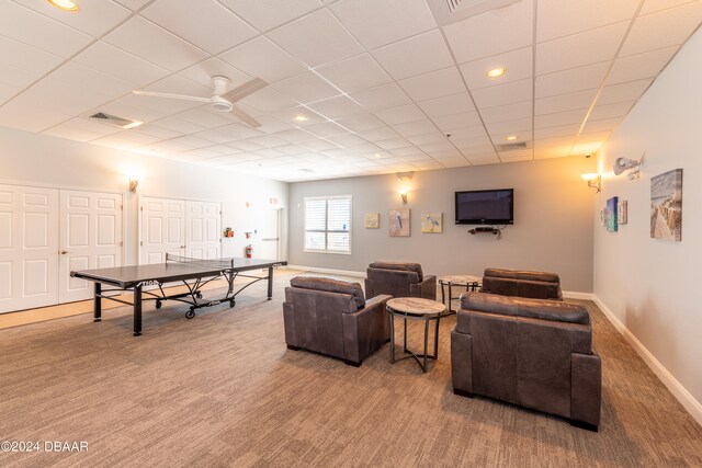 carpeted living room with ceiling fan