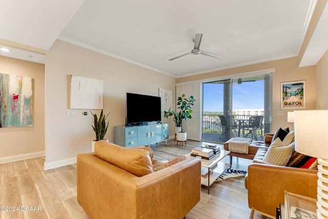 living room with light hardwood / wood-style floors, ceiling fan, and crown molding