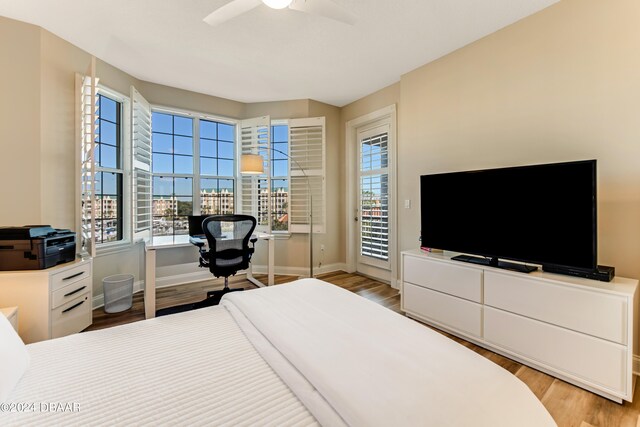 bedroom featuring ceiling fan, access to exterior, and light wood-type flooring