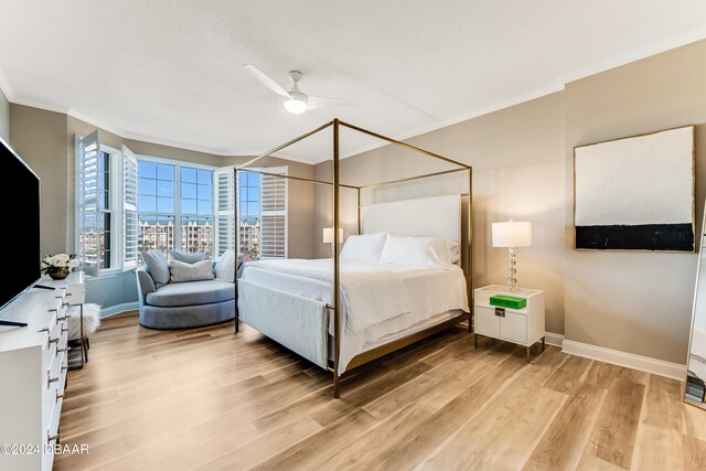 bedroom with ceiling fan, light hardwood / wood-style flooring, and ornamental molding