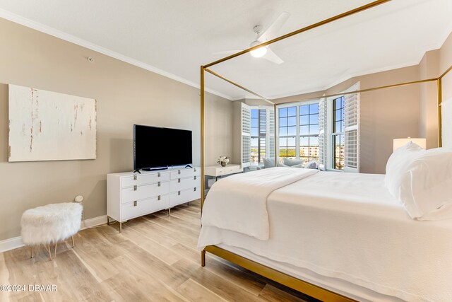 bedroom with light hardwood / wood-style floors, ceiling fan, and ornamental molding