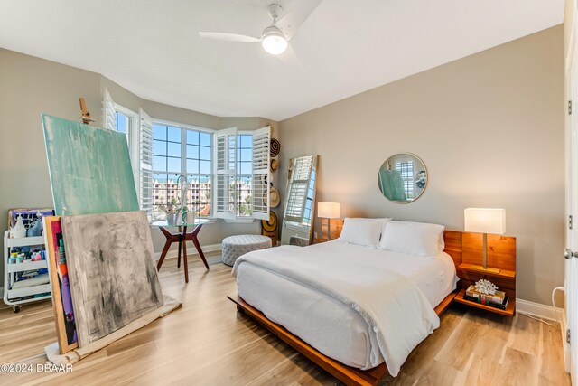 bedroom with hardwood / wood-style floors and ceiling fan