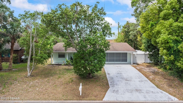 904 Woodmere Cir, Ormond Beach, FL 32174 - obstructed view of property featuring driveway and stucco siding