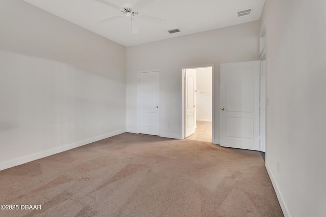 unfurnished bedroom featuring carpet floors, visible vents, ceiling fan, and baseboards