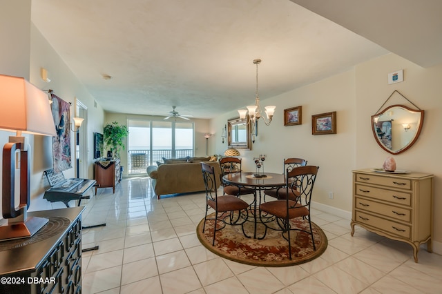 dining room featuring light tile patterned floors and ceiling fan with notable chandelier