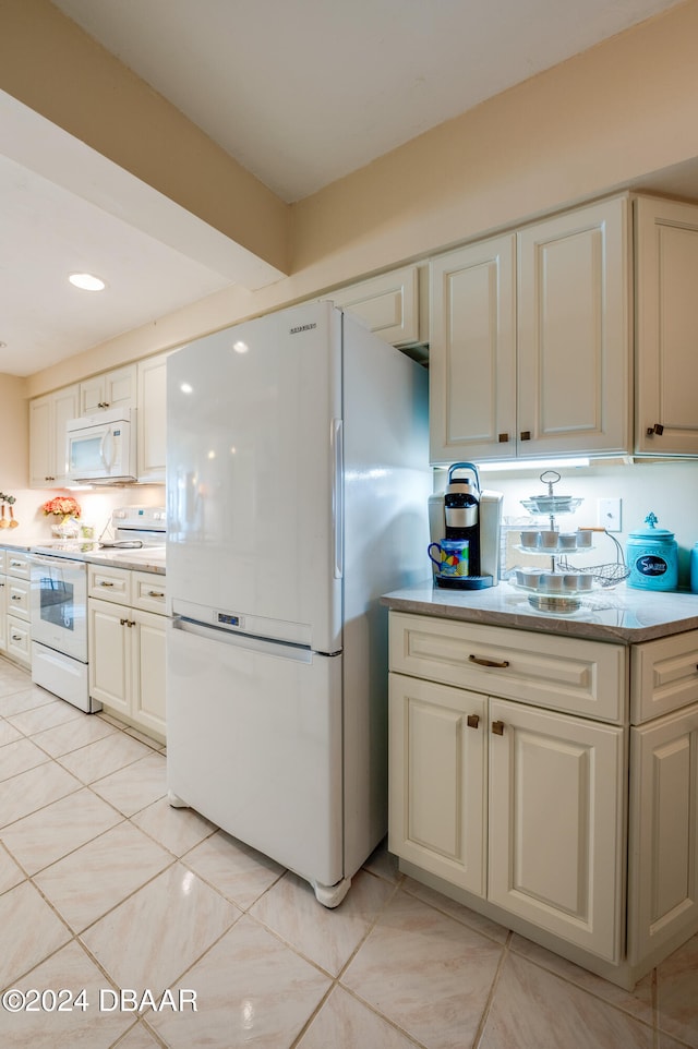 kitchen featuring white appliances and light tile patterned floors