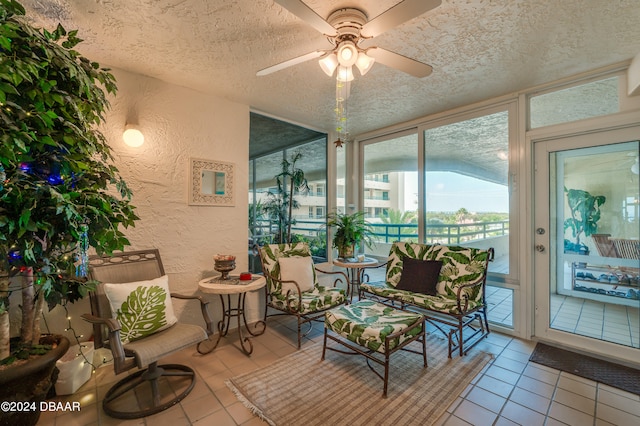 sunroom / solarium featuring ceiling fan