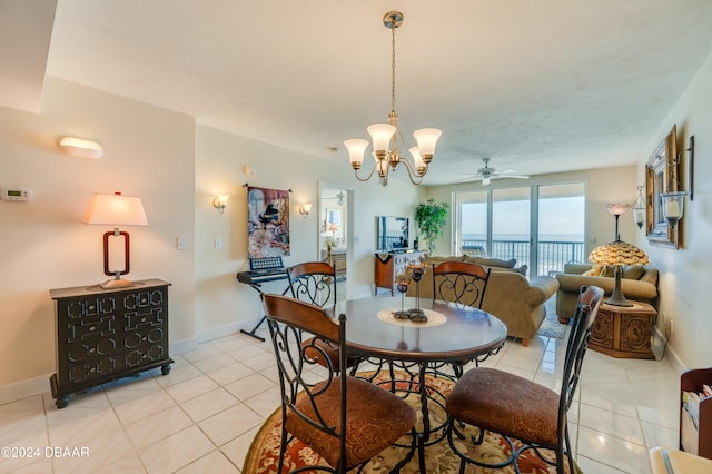 dining room with ceiling fan with notable chandelier and light tile patterned floors