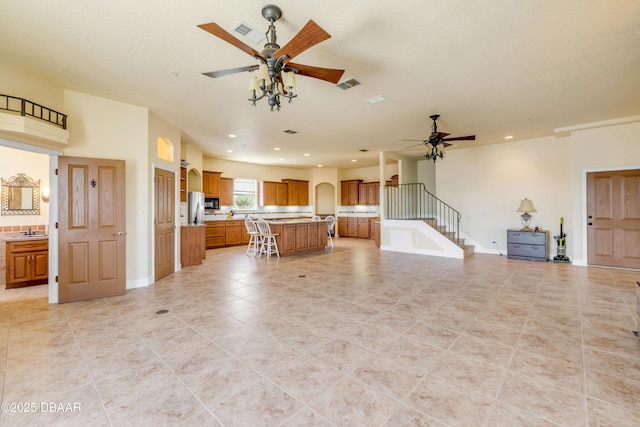 4690 S Atlantic Ave, Ponce Inlet, FL 32127 - unfurnished living room with ceiling fan, stairway, light tile patterned floors, and recessed lighting
