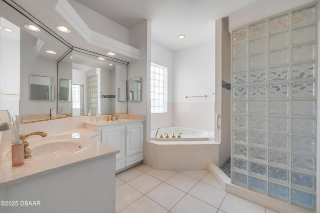 4690 S Atlantic Ave, Ponce Inlet, FL 32127 - bathroom featuring vanity, a garden tub, tile patterned flooring, recessed lighting, and tiled shower