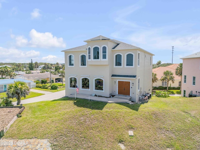 4690 S Atlantic Ave, Ponce Inlet, FL 32127 - mediterranean / spanish-style home with a front yard and stucco siding