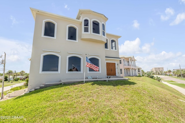 4690 S Atlantic Ave, Ponce Inlet, FL 32127 - view of front of house with a front yard and stucco siding