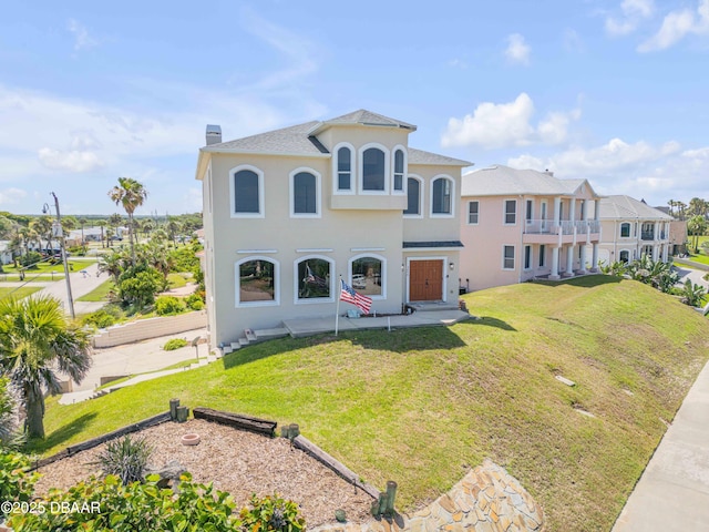 4690 S Atlantic Ave, Ponce Inlet, FL 32127 - view of front facade with stucco siding, a chimney, a front yard, and a residential view