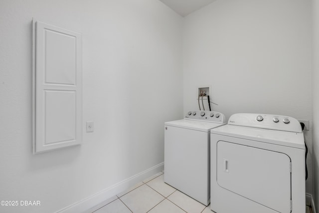4690 S Atlantic Ave, Ponce Inlet, FL 32127 - washroom featuring washing machine and dryer and light tile patterned floors