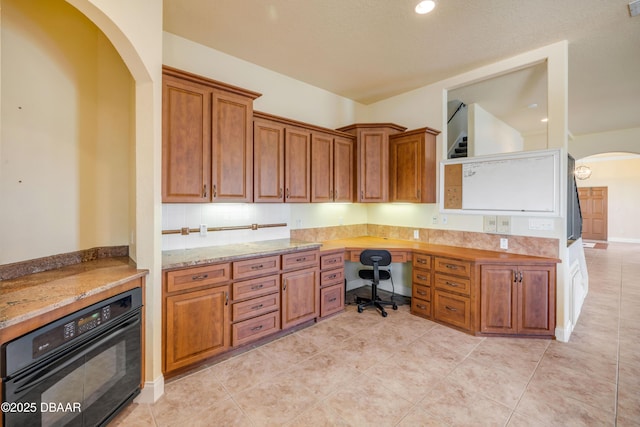 4690 S Atlantic Ave, Ponce Inlet, FL 32127 - unfurnished office with arched walkways, built in desk, light tile patterned floors, and recessed lighting