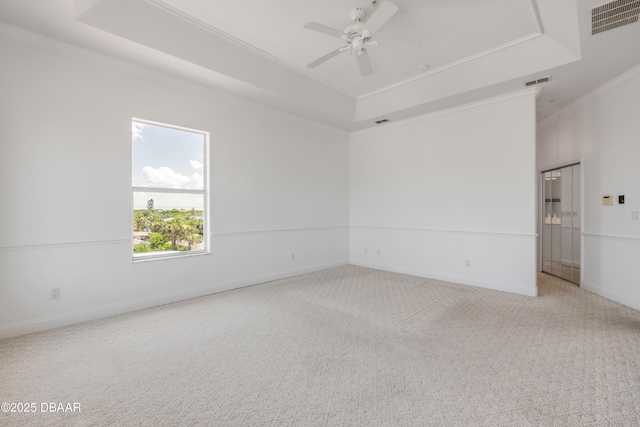 4690 S Atlantic Ave, Ponce Inlet, FL 32127 - carpeted empty room with a raised ceiling, ornamental molding, and a ceiling fan