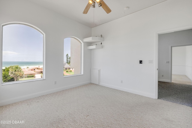 4690 S Atlantic Ave, Ponce Inlet, FL 32127 - spare room with carpet, ceiling fan, and a water view