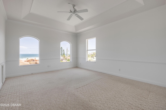 4690 S Atlantic Ave, Ponce Inlet, FL 32127 - spare room with a tray ceiling, ornamental molding, a ceiling fan, and light carpet