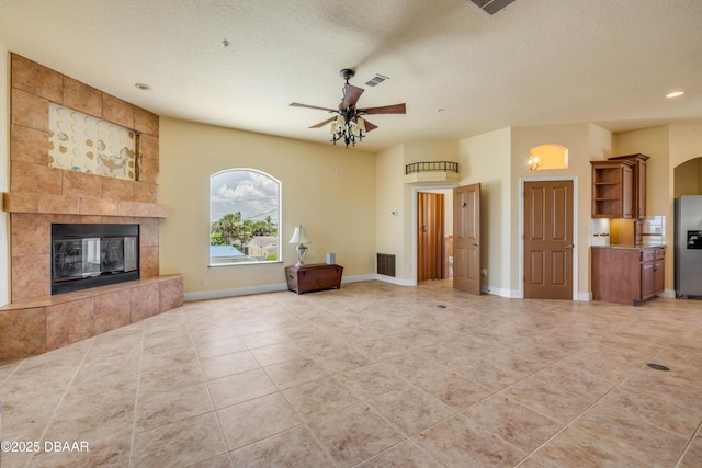 4690 S Atlantic Ave, Ponce Inlet, FL 32127 - unfurnished living room with ceiling fan, a tile fireplace, light tile patterned floors, a textured ceiling, and recessed lighting