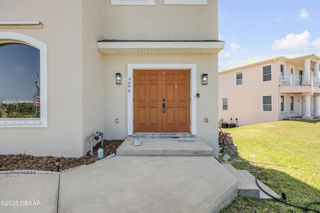 4690 S Atlantic Ave, Ponce Inlet, FL 32127 - property entrance featuring stucco siding and a lawn