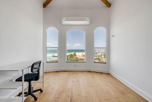 4690 S Atlantic Ave, Ponce Inlet, FL 32127 - unfurnished office with light wood finished floors, plenty of natural light, beamed ceiling, a water view, and a towering ceiling