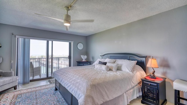 bedroom with a textured ceiling, access to outside, ceiling fan, and light tile patterned flooring