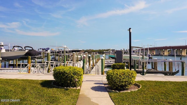 exterior space featuring a water view, a boat dock, and a lawn