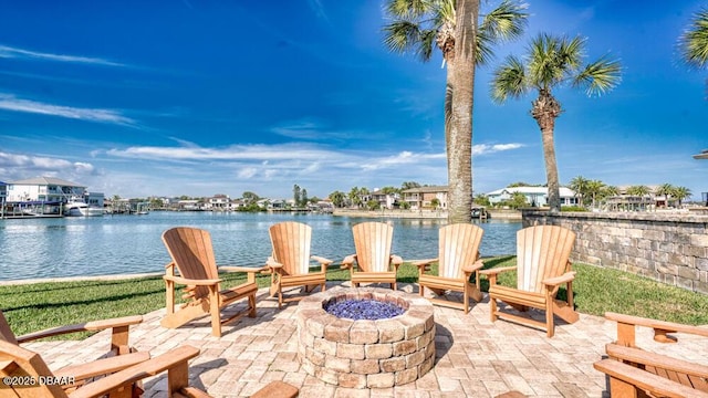 view of patio with a water view and a fire pit