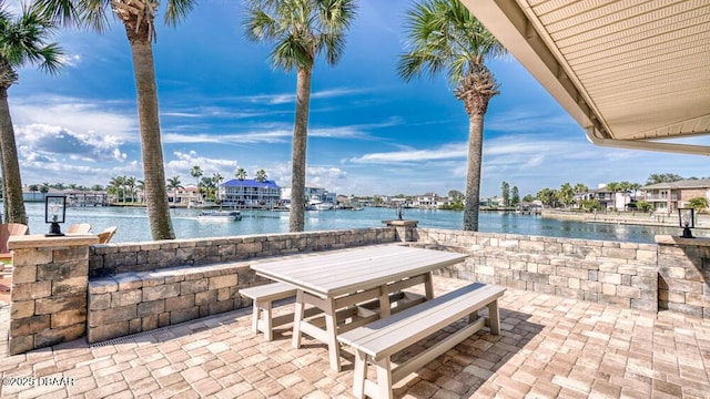 view of patio with a water view