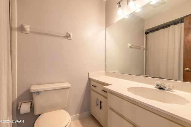 bathroom featuring vanity, tile patterned floors, toilet, and walk in shower