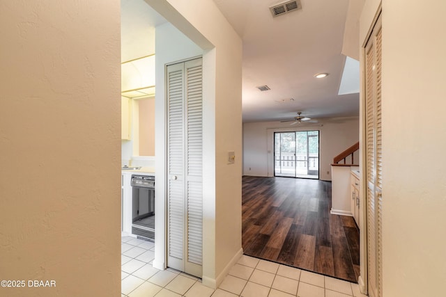 hallway featuring light tile patterned flooring