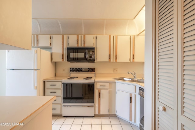 kitchen with light tile patterned floors, sink, and black appliances