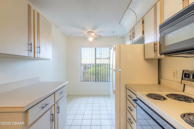 kitchen with electric stove, light tile patterned floors, and ceiling fan