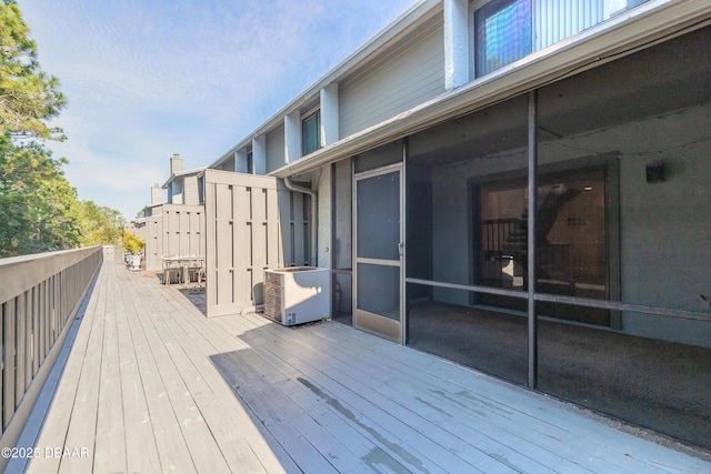 wooden deck featuring a sunroom