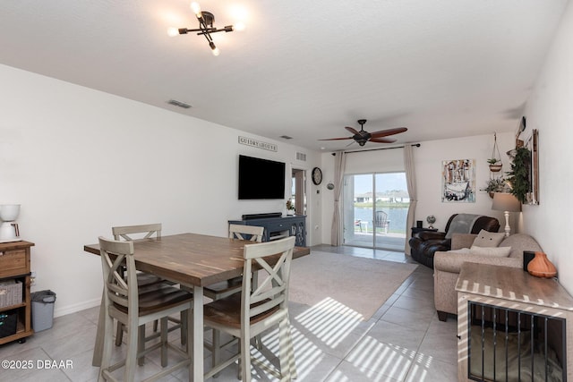 tiled dining area featuring ceiling fan