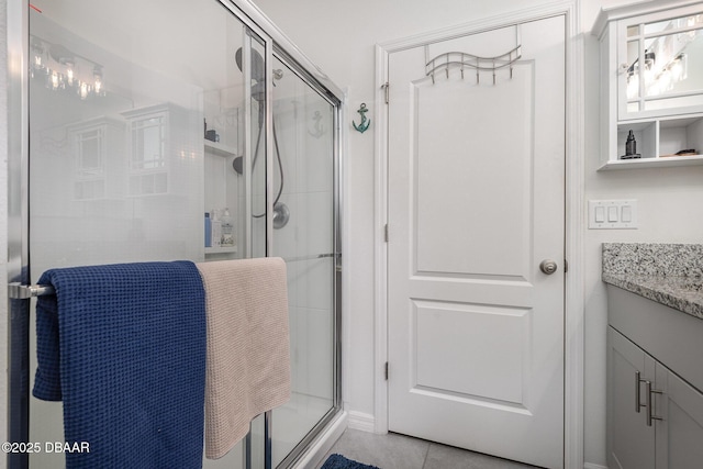 bathroom featuring vanity, an enclosed shower, and tile patterned flooring