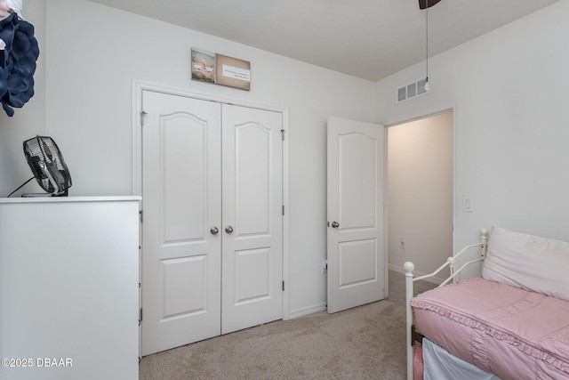 carpeted bedroom featuring a closet