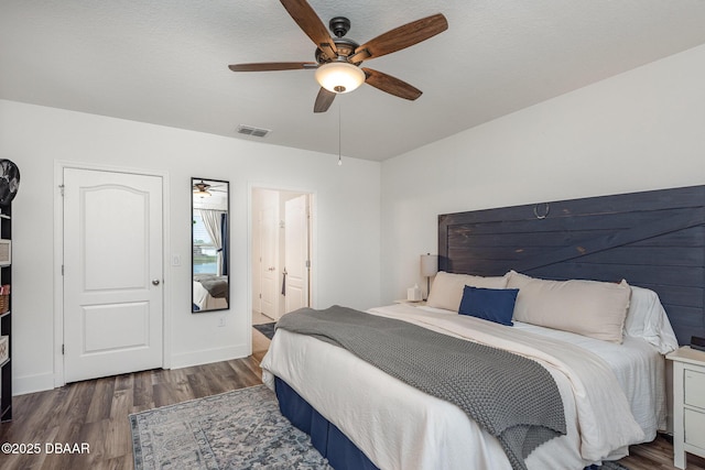 bedroom featuring ceiling fan and dark hardwood / wood-style flooring