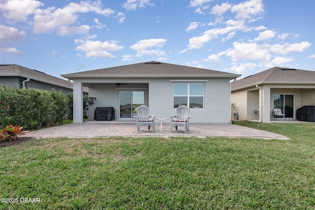 back of property featuring a patio area and a lawn