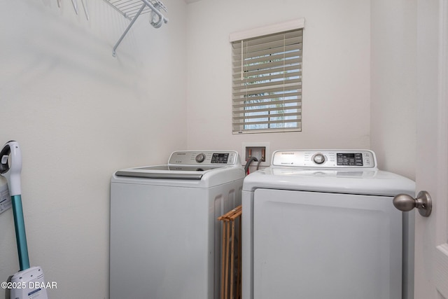 clothes washing area with washing machine and dryer