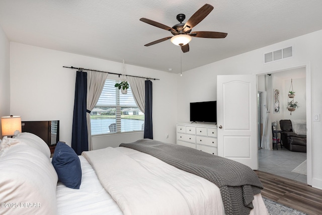 bedroom featuring lofted ceiling, hardwood / wood-style flooring, and ceiling fan