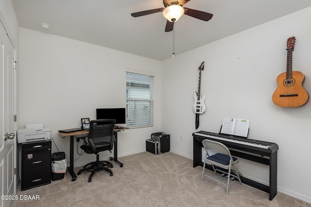 carpeted office space featuring ceiling fan