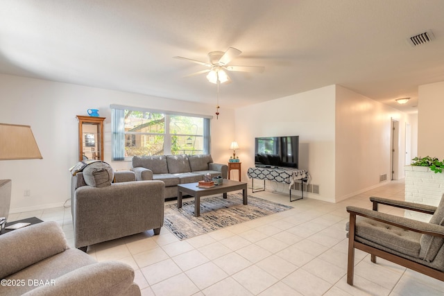 living room with ceiling fan, visible vents, baseboards, and light tile patterned flooring