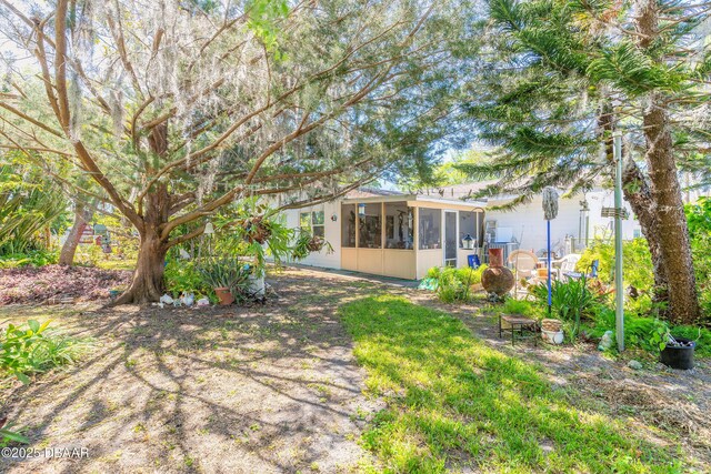 view of yard featuring a sunroom