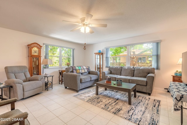 living room featuring light tile patterned floors, plenty of natural light, and a ceiling fan