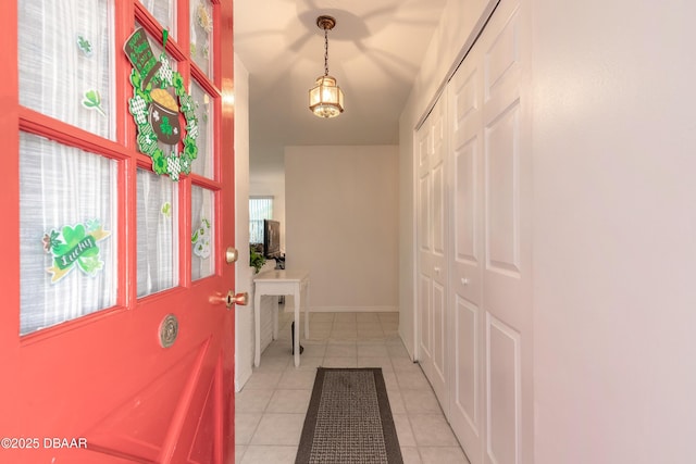 entryway featuring light tile patterned floors and baseboards