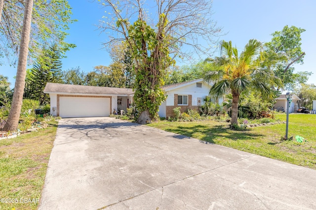 view of front of house with a front lawn, concrete driveway, and a garage