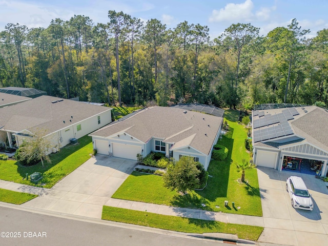 birds eye view of property featuring a view of trees