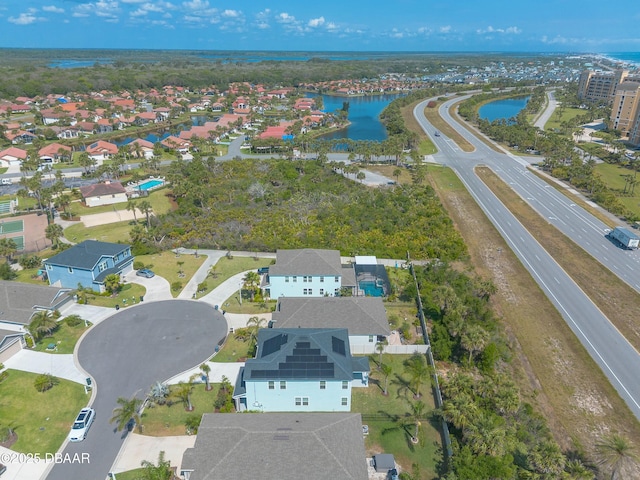 drone / aerial view featuring a residential view and a water view